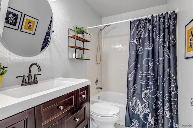 full bath featuring a textured wall, shower / bath combo with shower curtain, toilet, and vanity