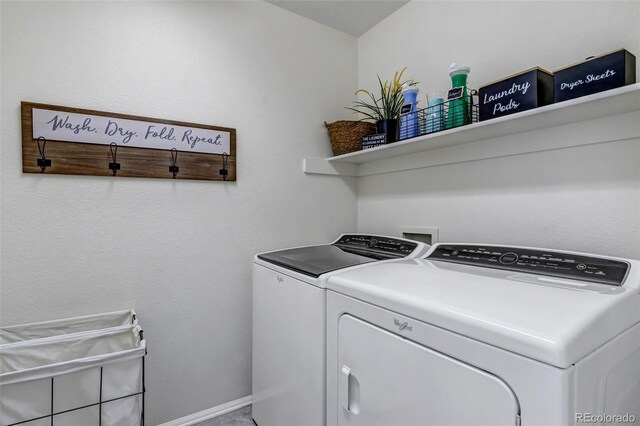 laundry area featuring baseboards, separate washer and dryer, and laundry area