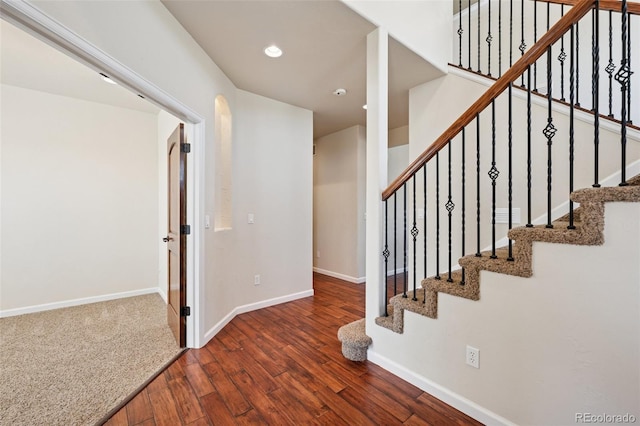 1890 Bel Lago Vw, Monument, CO 80132 - stairs featuring wood finished floors, baseboards, recessed lighting, and arched walkways