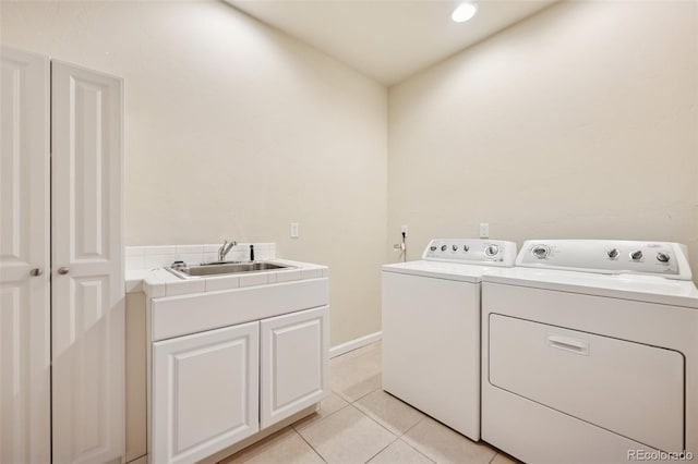 1890 Bel Lago Vw, Monument, CO 80132 - laundry room featuring washer and clothes dryer, cabinet space, and light tile patterned flooring