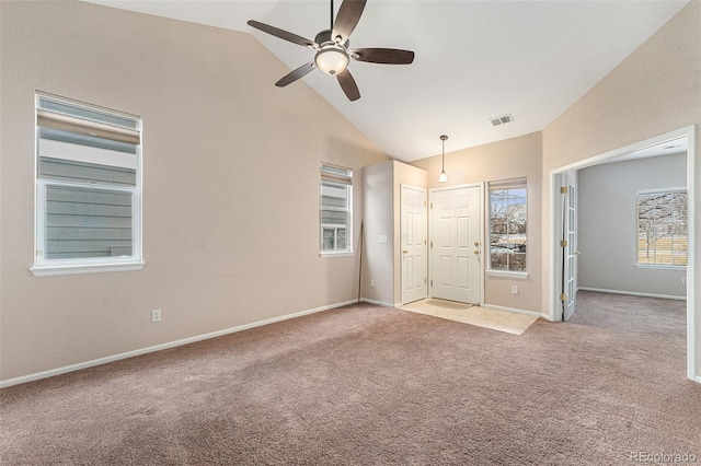 interior space featuring ceiling fan, light colored carpet, and high vaulted ceiling