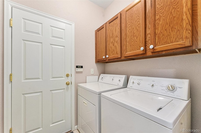 laundry area featuring cabinets and washing machine and clothes dryer