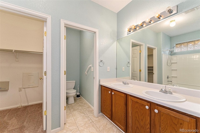 full bathroom with tile patterned flooring, vanity, shower / bath combination, and toilet