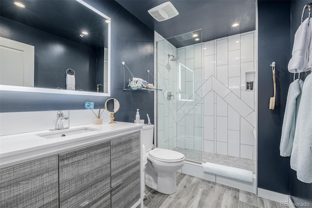 1700 Bassett St Unit 513, Denver, CO 80202 - bathroom with toilet, walk in shower, wood finished floors, and vanity