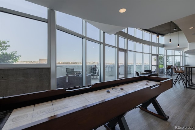 1700 Bassett St Unit 513, Denver, CO 80202 - recreation room featuring wood finished floors, a wall of windows, and a towering ceiling