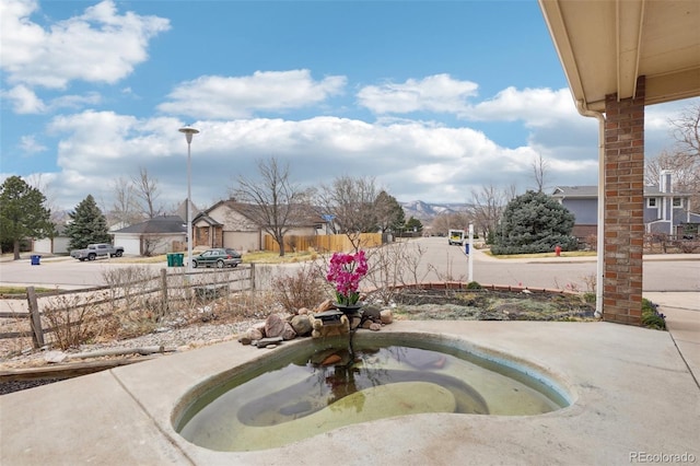 view of swimming pool featuring fence