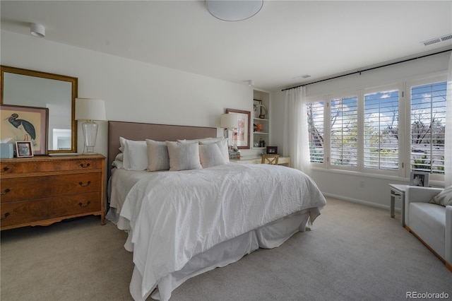 carpeted bedroom with visible vents and baseboards