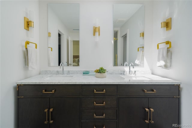 bathroom featuring double vanity and a sink