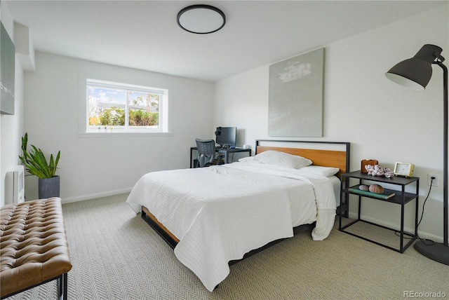 carpeted bedroom featuring baseboards