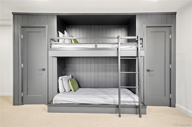 carpeted bedroom featuring baseboards