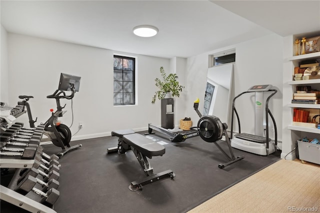 workout room featuring baseboards
