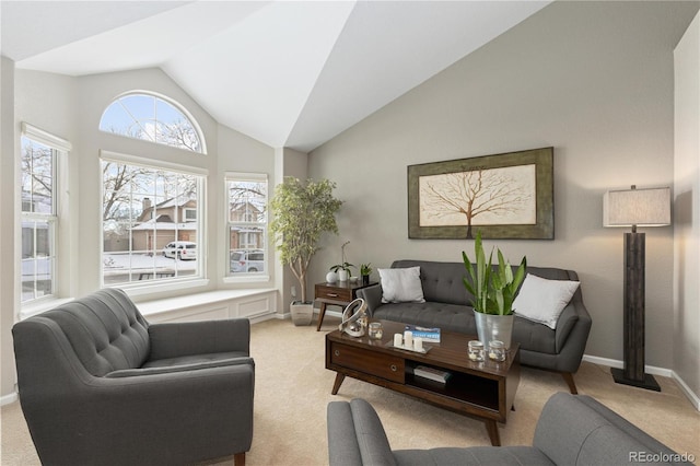 living room with light colored carpet and vaulted ceiling