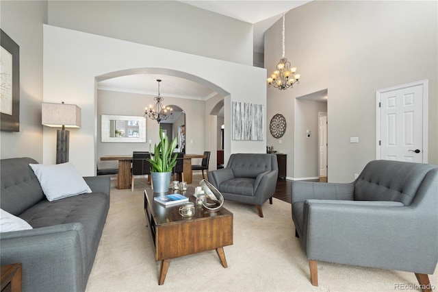 living room with ornamental molding, carpet flooring, and an inviting chandelier