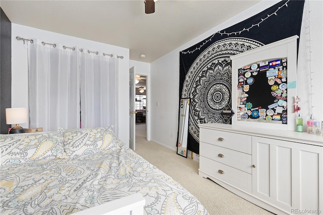 bedroom featuring ceiling fan and light colored carpet