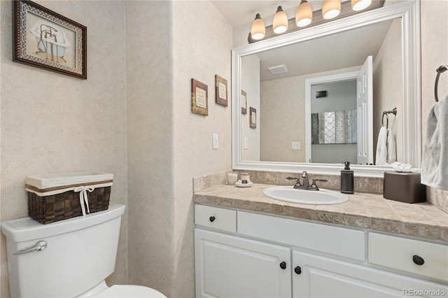 bathroom with vanity and toilet