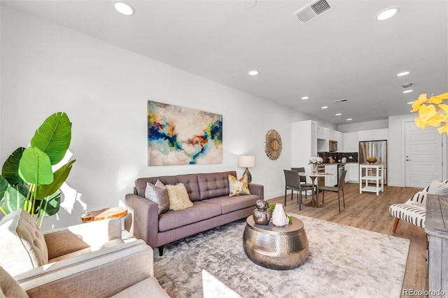 living room with light hardwood / wood-style flooring