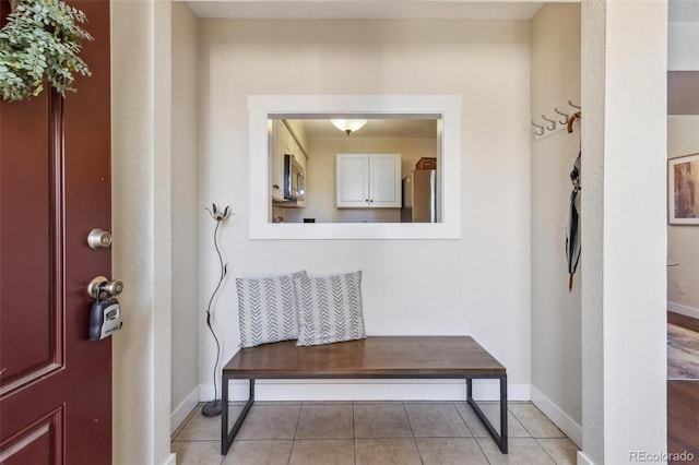 entrance foyer featuring light tile patterned flooring and baseboards