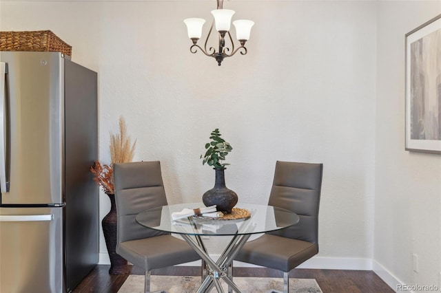 dining area with baseboards and dark wood-style floors