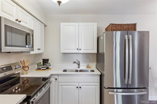 kitchen with light countertops, a sink, white cabinets, and stainless steel appliances
