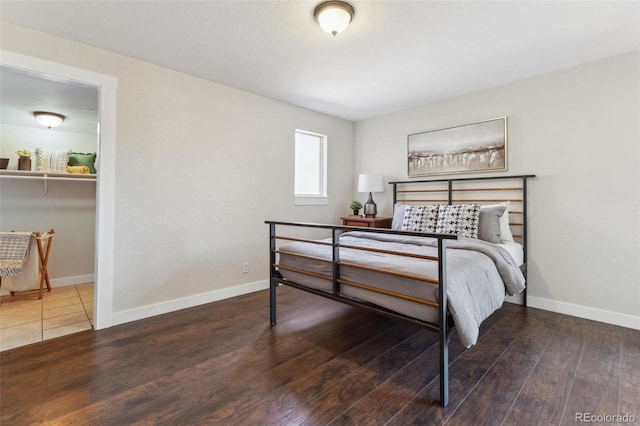 bedroom featuring wood finished floors and baseboards