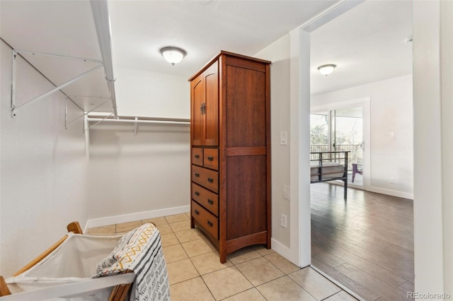 spacious closet featuring light tile patterned floors
