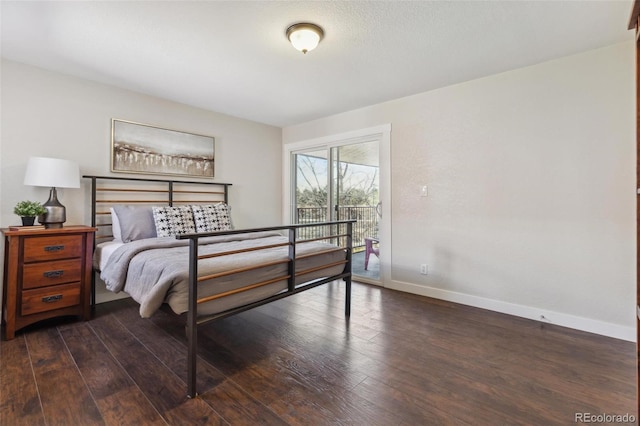bedroom featuring access to exterior, baseboards, and dark wood finished floors