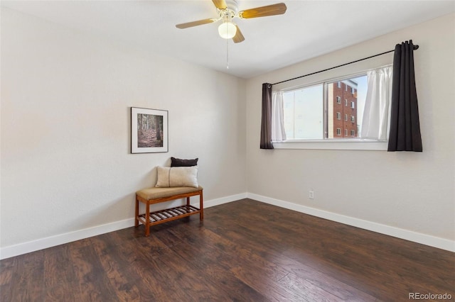 living area with ceiling fan, baseboards, and wood finished floors