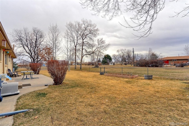 view of yard featuring a garden, a patio, and fence