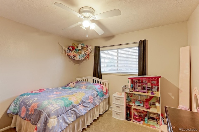 bedroom featuring a ceiling fan, carpet flooring, and a textured ceiling