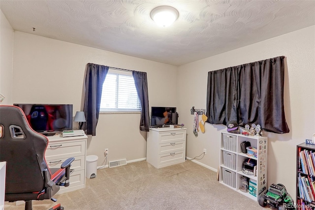 carpeted home office featuring visible vents and baseboards