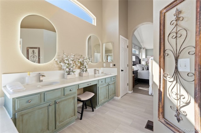 full bath with ensuite bathroom, double vanity, a sink, and visible vents