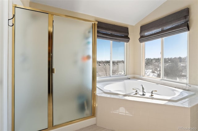 full bathroom with lofted ceiling, a garden tub, and a shower stall