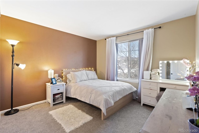 carpeted bedroom featuring baseboards