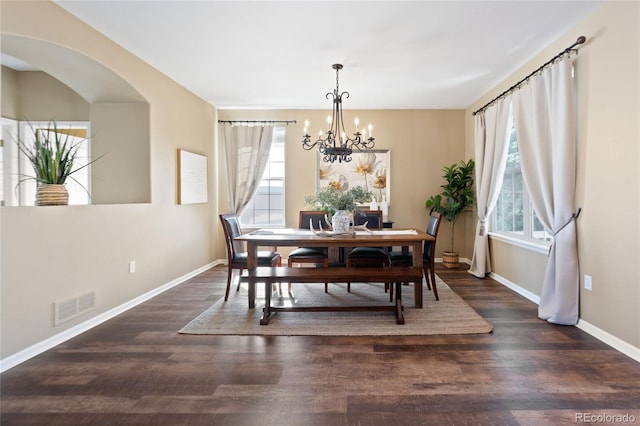 dining room featuring baseboards, visible vents, and wood finished floors