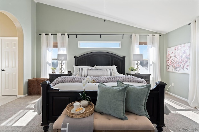 bedroom with lofted ceiling, carpet, arched walkways, and baseboards