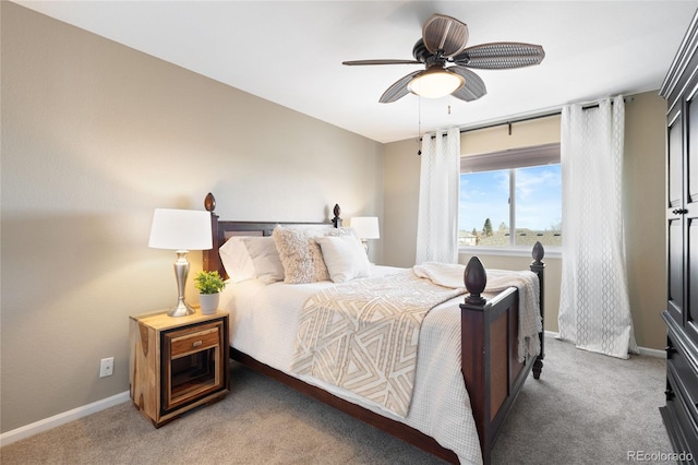 bedroom with light colored carpet, ceiling fan, and baseboards