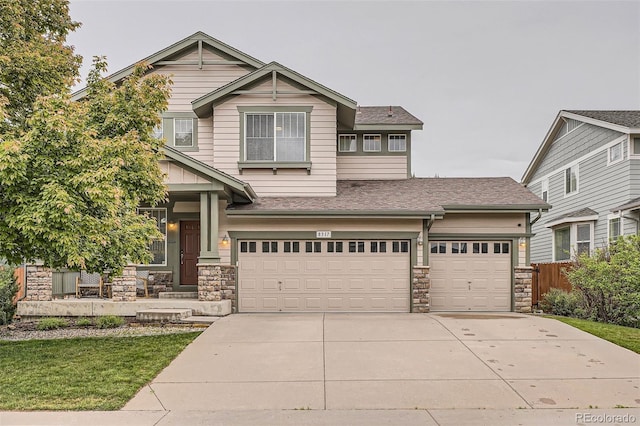 8317 Liverpool Cir, Littleton, CO 80125 - craftsman house featuring stone siding, driveway, a shingled roof, and a garage