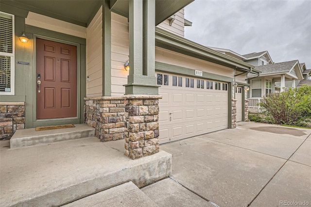 8317 Liverpool Cir, Littleton, CO 80125 - property entrance featuring concrete driveway, stone siding, and a porch