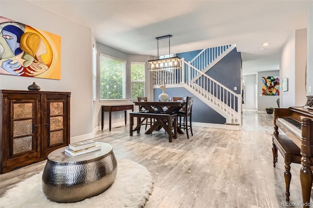 8317 Liverpool Cir, Littleton, CO 80125 - dining room featuring stairway, a chandelier, baseboards, and wood finished floors