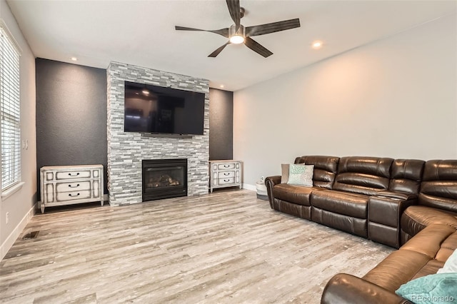 8317 Liverpool Cir, Littleton, CO 80125 - living area with ceiling fan, baseboards, wood finished floors, a stone fireplace, and recessed lighting