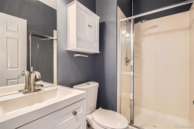 8317 Liverpool Cir, Littleton, CO 80125 - full bathroom featuring a textured wall, a stall shower, toilet, and vanity