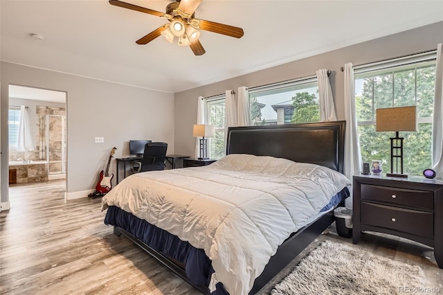 8317 Liverpool Cir, Littleton, CO 80125 - bedroom with multiple windows, wood finished floors, baseboards, and ensuite bath