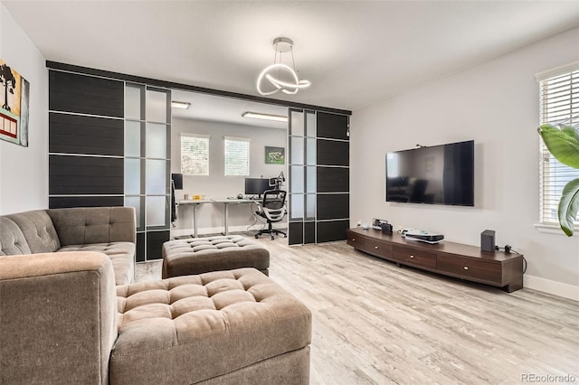 8317 Liverpool Cir, Littleton, CO 80125 - living area featuring wood finished floors, a desk, healthy amount of natural light, and a chandelier