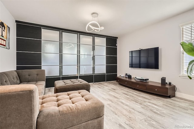 8317 Liverpool Cir, Littleton, CO 80125 - living area with wood finished floors, a chandelier, and baseboards