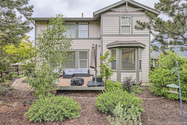 8317 Liverpool Cir, Littleton, CO 80125 - view of front of house featuring a wooden deck and outdoor lounge area
