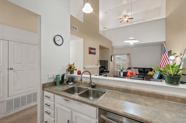 5800 Tower Rd Unit 610, Denver, CO 80249 - kitchen featuring white cabinets, hanging light fixtures, high vaulted ceiling, open floor plan, and carpet