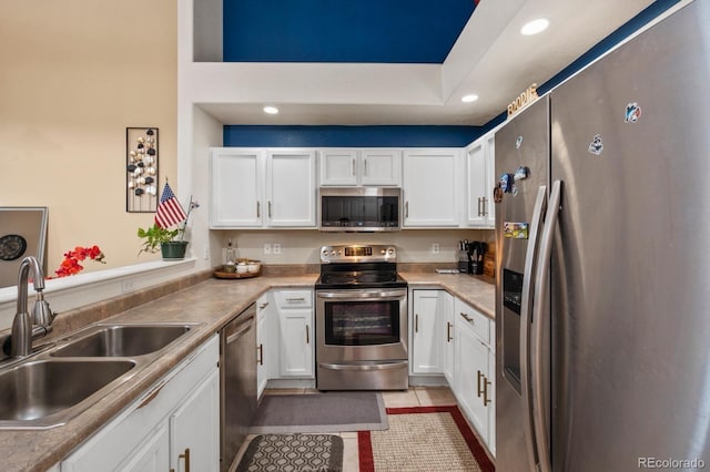 5800 Tower Rd Unit 610, Denver, CO 80249 - kitchen featuring appliances with stainless steel finishes, white cabinets, recessed lighting, light countertops, and light tile patterned floors