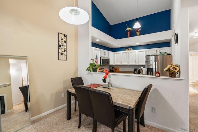 5800 Tower Rd Unit 610, Denver, CO 80249 - dining room featuring light carpet and high vaulted ceiling