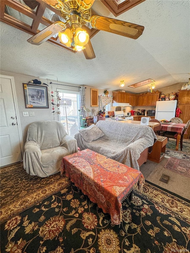 312 Ceratosaurus Cir, Dinosaur, CO 81610 - bedroom featuring ceiling fan, carpet, lofted ceiling, freestanding refrigerator, and a textured ceiling