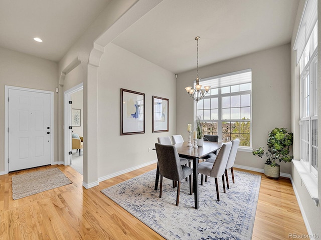 dining area featuring an inviting chandelier, baseboards, recessed lighting, and light wood finished floors